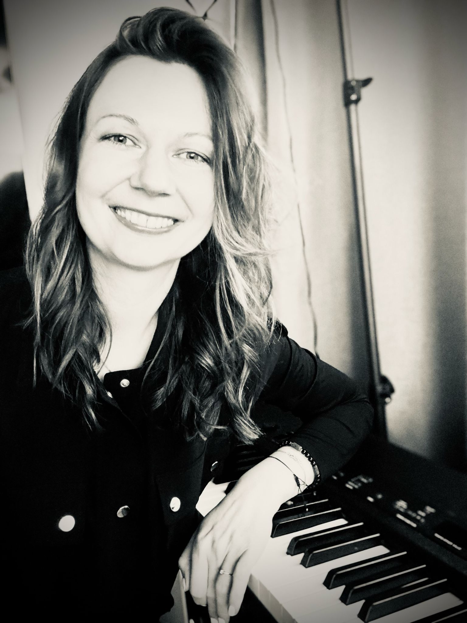 Agi at the piano — founder of Agi And The Keys